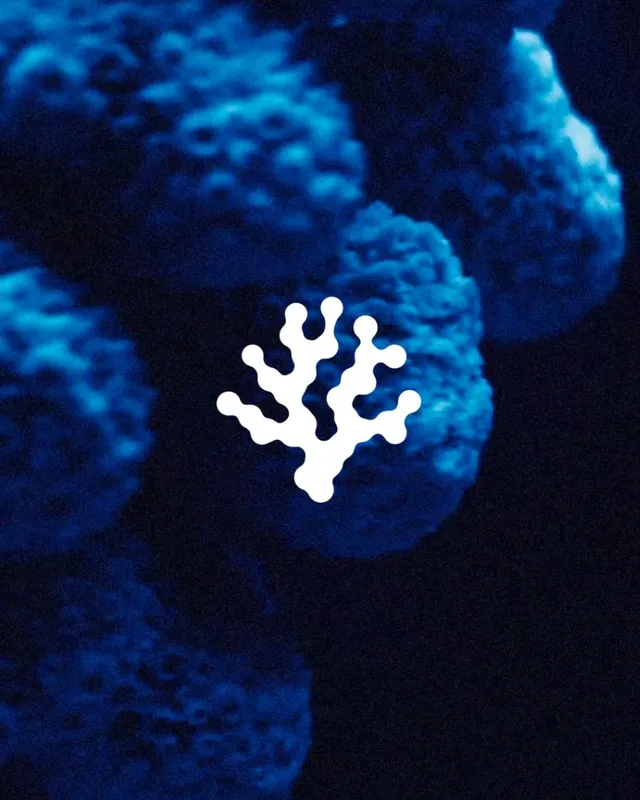A blue coral close up with the Coral Gardeners mark