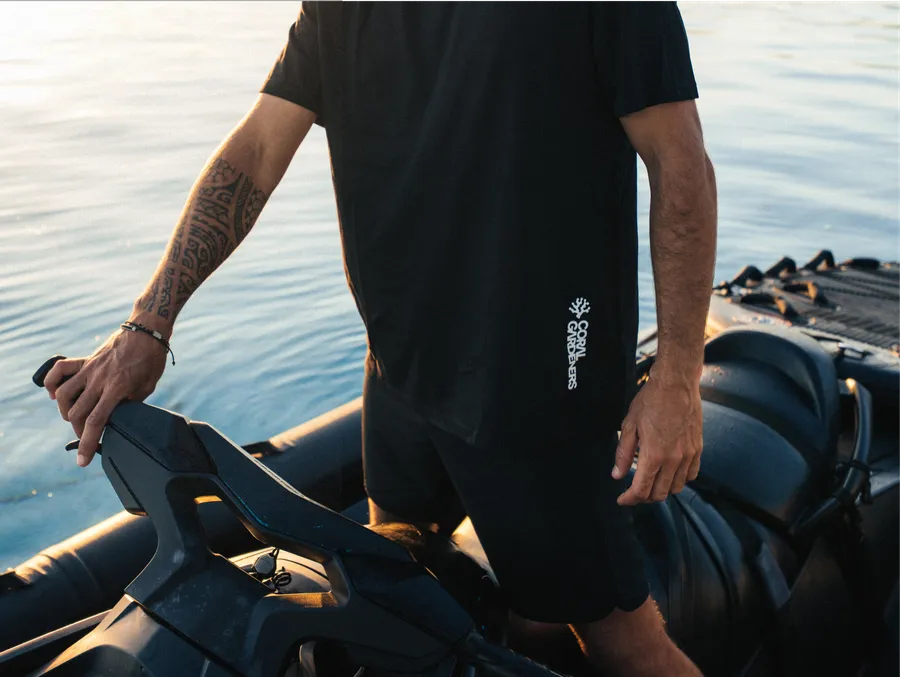 A Gardener on the boat in a black tee