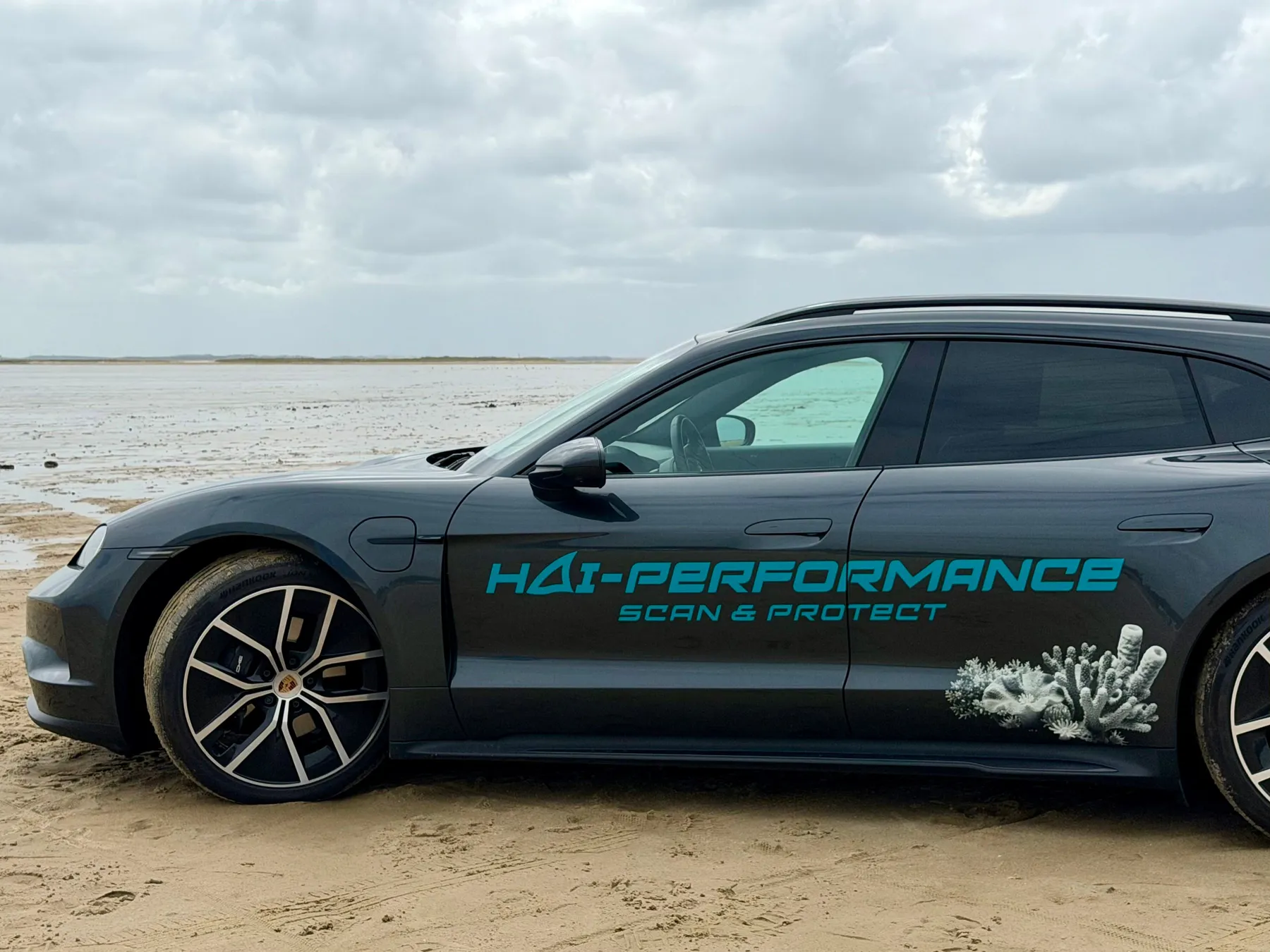 The HAI-PERFORMANCE Porsche Taycan parked on a beach
