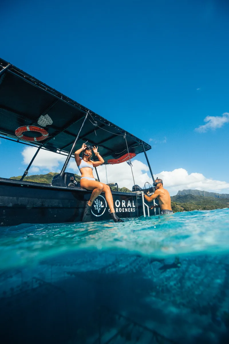 The Coral Gardeners boat on the lagoon, seen half underwater
